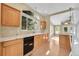 Bright kitchen with wood cabinets, marble countertops, and sleek black appliances at 7870 Sunflower Green # 151, Frederick, CO 80530