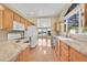 Spacious kitchen with marble countertops, wood cabinets, and seamless access to adjacent rooms at 7870 Sunflower Green # 151, Frederick, CO 80530