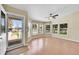 Bright living room with a wall of windows and wood-look floors at 7870 Sunflower Green # 151, Frederick, CO 80530