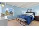 Serene bedroom features a cozy bed with blue bedding, a large window, and natural light at 4801 E 9Th Ave # 209S, Denver, CO 80220