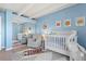 This Bedroom includes a white crib, gray chair, and animal-themed decorations for a cozy and inviting space at 4801 E 9Th Ave # 209S, Denver, CO 80220