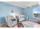 Bright Bedroom with a comfortable chair and a white crib beside a window, decorated with fun animal themes at 4801 E 9Th Ave # 209S, Denver, CO 80220