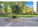 Manicured courtyard features mature trees, green grass and a central planter, all well-maintained at 4801 E 9Th Ave # 209S, Denver, CO 80220