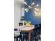 Dining area featuring modern chandelier, table setting, and bright interior paint at 4801 E 9Th Ave # 209S, Denver, CO 80220