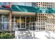 Entrance to building featuring glass doors and handicap access with decorative mid-century concrete wall at 4801 E 9Th Ave # 209S, Denver, CO 80220