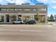 Modern building with commercial spaces 'Alchemy Face Bar', featuring street parking and well-manicured landscaping at 4801 E 9Th Ave # 209S, Denver, CO 80220