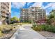 Modern apartment building showcasing meticulously landscaped grounds and pedestrian pathway at 4801 E 9Th Ave # 209S, Denver, CO 80220