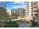 Exterior view of apartment building with manicured lawns, landscaping, and walking paths at 4801 E 9Th Ave # 209S, Denver, CO 80220