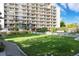 Lush green lawn providing an open space for residents with a tall apartment building in the background at 4801 E 9Th Ave # 209S, Denver, CO 80220