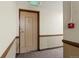 Hallway leading to apartment featuring neutral wall colors and patterned carpet at 4801 E 9Th Ave # 209S, Denver, CO 80220