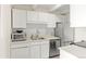 A bright kitchen with white cabinets and stainless steel appliances offers a clean and modern look at 4801 E 9Th Ave # 209S, Denver, CO 80220