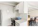 View of a well-equipped kitchen with white cabinets and stainless steel appliances connects to the dining area at 4801 E 9Th Ave # 209S, Denver, CO 80220