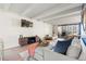 Bright living room features modern furniture, hardwood floors, stylish decor and a balcony at 4801 E 9Th Ave # 209S, Denver, CO 80220