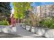 Landscaped walkway leading to community amenities near mature trees and the apartment building at 4801 E 9Th Ave # 209S, Denver, CO 80220
