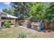 Nice backyard with a covered patio and a playhouse next to a wooden fence at 100 Dudley St, Lakewood, CO 80226