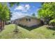 View of the backyard showing the siding, fencing, landscaping, and access to the covered back patio at 100 Dudley St, Lakewood, CO 80226