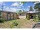 The backyard features a utility shed, covered patio, and mature trees and shrubs for added privacy at 100 Dudley St, Lakewood, CO 80226