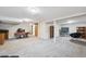 Spacious basement featuring neutral carpet, a sliding barn door, and ample space for various activities at 100 Dudley St, Lakewood, CO 80226