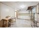 Unfinished basement area with a desk, sewing machine, laundry sink, and white cabinets for extra storage at 100 Dudley St, Lakewood, CO 80226