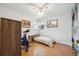 Bright bedroom with hardwood floors, ceiling fan, and a bed, perfect for relaxation and rest at 100 Dudley St, Lakewood, CO 80226
