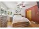 Comfortable bedroom with a large window, hardwood floors, and traditional furnishings at 100 Dudley St, Lakewood, CO 80226