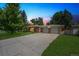 Charming single-story brick home with an attached two-car garage and a long driveway at 100 Dudley St, Lakewood, CO 80226