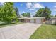 Charming single-story brick home with an attached two-car garage and a long driveway at 100 Dudley St, Lakewood, CO 80226
