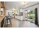Bright kitchen with white cabinets, mosaic backsplash, stainless steel appliances, and sliding door to the outside at 100 Dudley St, Lakewood, CO 80226
