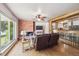 Inviting living room with a brick fireplace, hardwood floors, and a large window with natural light at 100 Dudley St, Lakewood, CO 80226
