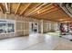 Partially finished basement featuring sliding doors, exposed beams, and a gym area at 22527 E Layton Cir, Aurora, CO 80015