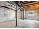 Unfinished basement featuring concrete floor, white walls, and two windows for natural light at 22527 E Layton Cir, Aurora, CO 80015