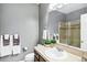 Well-lit bathroom features neutral tile countertop, shower, sink and fixtures, and decorative towels at 22527 E Layton Cir, Aurora, CO 80015