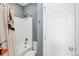 Bathroom featuring a toilet, bathtub, shower, gold fixtures, and a white shower curtain and door at 22527 E Layton Cir, Aurora, CO 80015
