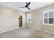 Bright bedroom with a ceiling fan, carpeted floor, and walk-in closet provides comfort and convenience at 22527 E Layton Cir, Aurora, CO 80015