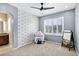 Bedroom featuring blue walls, plush carpeting, a ceiling fan, a small desk, and a window with plantation shutters at 22527 E Layton Cir, Aurora, CO 80015