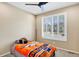 Bedroom with a ceiling fan, neutral carpet, large windows and bright orange and blue color scheme at 22527 E Layton Cir, Aurora, CO 80015