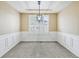 Traditional dining room showcasing wainscoting and a modern chandelier with natural light and neutral color palette at 22527 E Layton Cir, Aurora, CO 80015