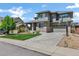 Attractive two-story home with green lawn, two car garage, lush landscaping and a basketball hoop at 22527 E Layton Cir, Aurora, CO 80015