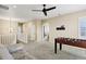 Hallway with plush carpeting, an arched doorway, and a foosball table at the end of the hallway at 22527 E Layton Cir, Aurora, CO 80015