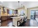 Spacious kitchen with granite countertops, dark wood cabinets, stainless steel appliances, and a large center island at 22527 E Layton Cir, Aurora, CO 80015