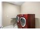This laundry room features a full sized washer and dryer, perfect for handling all laundry needs at 22527 E Layton Cir, Aurora, CO 80015