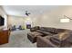 Comfortable living room features a leather sectional, a cozy fireplace, and modern entertainment setup at 22527 E Layton Cir, Aurora, CO 80015