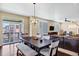 Open living space with dining area, leading to an outdoor deck, with natural light and modern furnishings at 22527 E Layton Cir, Aurora, CO 80015