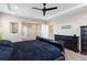 An airy primary bedroom featuring tray ceilings, recessed lights, and a view to the ensuite bathroom at 22527 E Layton Cir, Aurora, CO 80015