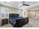 A luxurious primary bedroom with tray ceilings, recessed lights, and large windows for natural light at 22527 E Layton Cir, Aurora, CO 80015