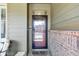 Inviting front porch with a secured entrance door and a brick pillar at 22527 E Layton Cir, Aurora, CO 80015