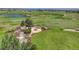 Landscaped backyard with firepit, stone benches, a water feature and green grass overlooking rolling hills at 5149 Raintree Dr, Parker, CO 80134