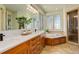 Bathroom with marble countertops, undermount sink, decorative windows, and walk-in shower at 5149 Raintree Dr, Parker, CO 80134