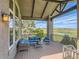 Enjoy serene water views from this comfortable deck with stylish outdoor seating and a covered roof at 5149 Raintree Dr, Parker, CO 80134