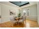Inviting dining room with statement lighting, hardwood floors and a painting of a buffalo at 5149 Raintree Dr, Parker, CO 80134